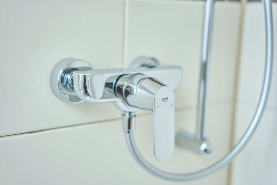 Hypo-allergenic bedding, desk, laptop workspace, blackout drapes