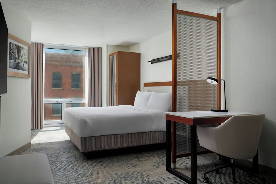 Premium bedding, desk, laptop workspace, blackout drapes