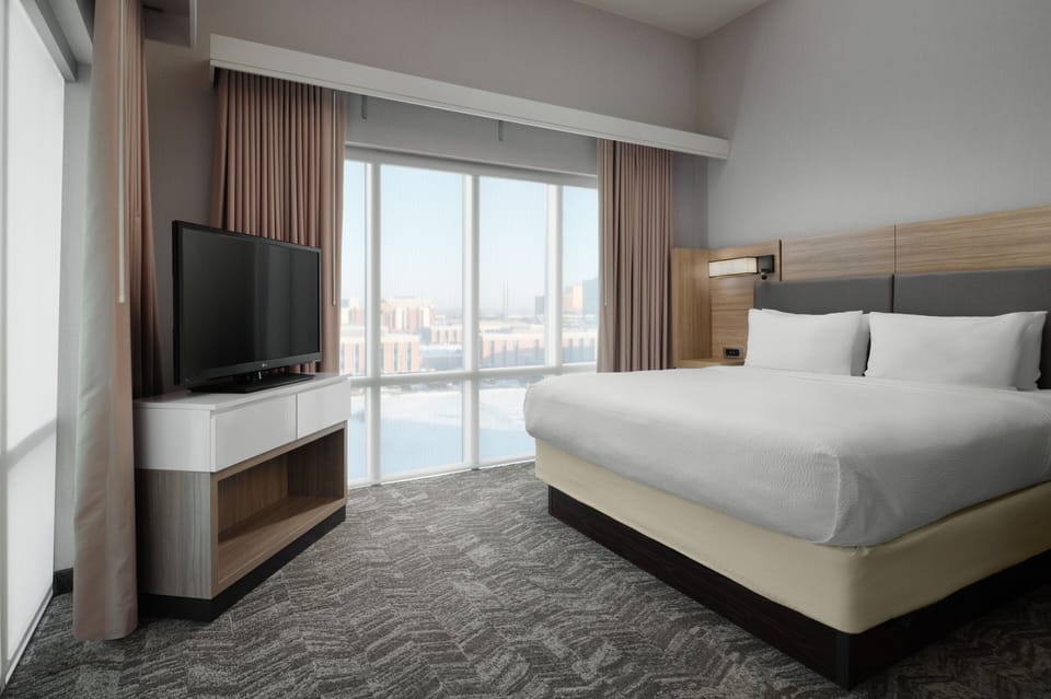 Premium bedding, desk, laptop workspace, blackout drapes
