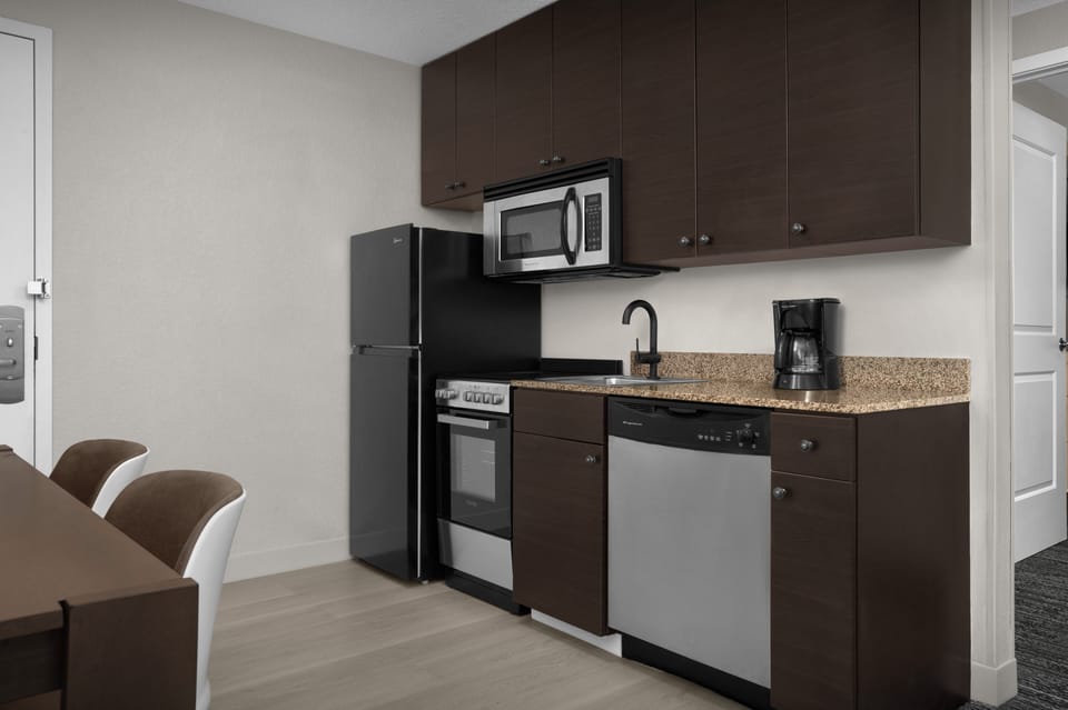Suite, 2 Bedrooms | Private kitchen | Full-size fridge, microwave, stovetop, dishwasher
