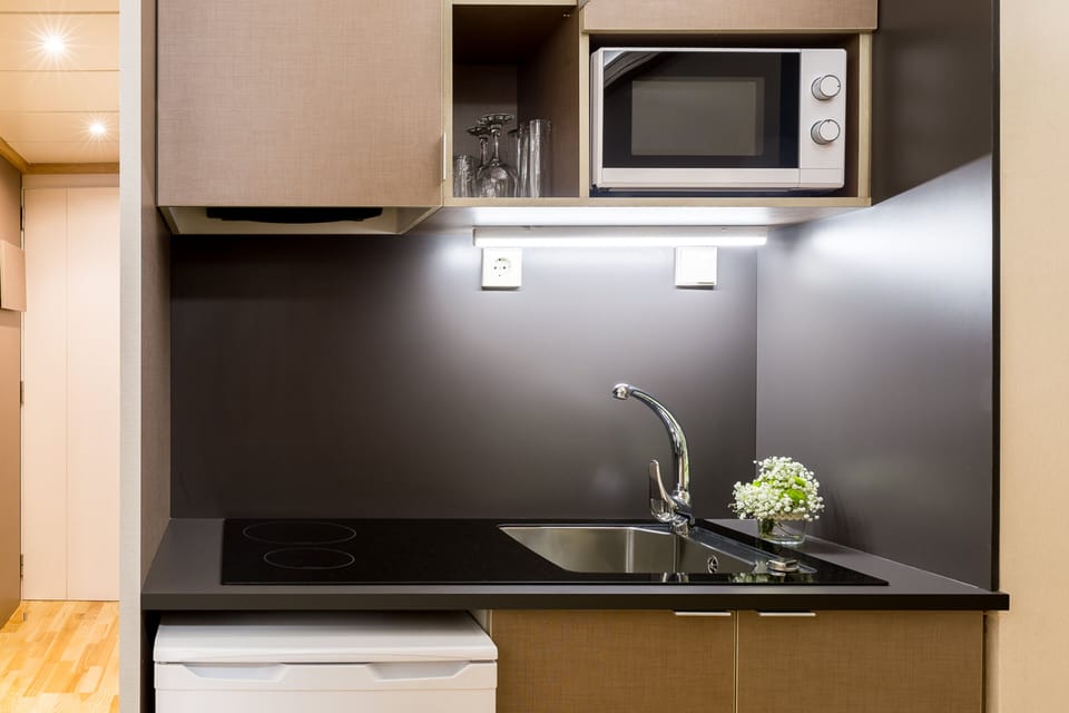 Standard Suite, Kitchenette | Private kitchen | Fridge, microwave, stovetop, cookware/dishes/utensils