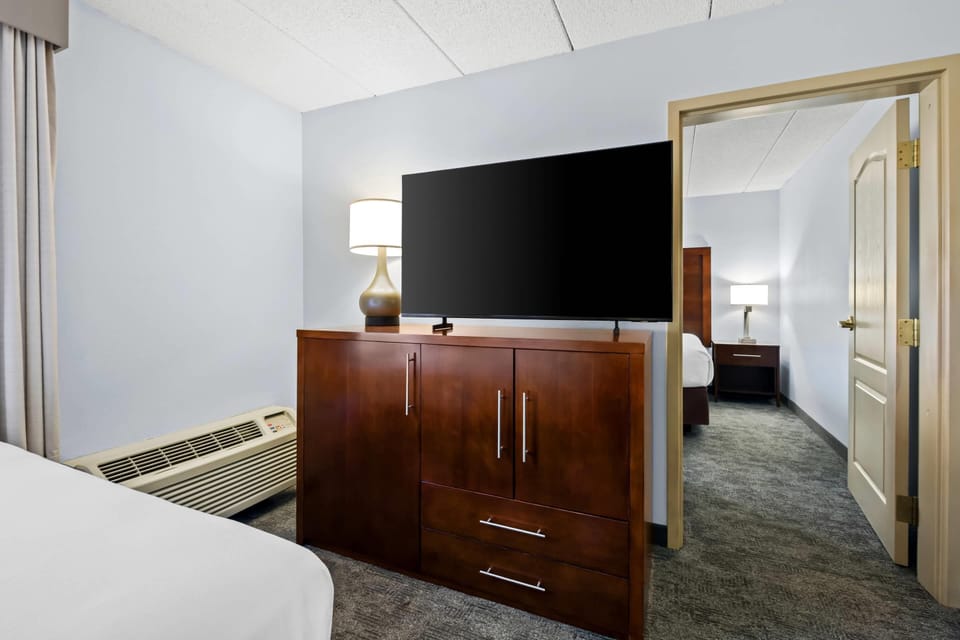 Premium bedding, desk, laptop workspace, blackout drapes