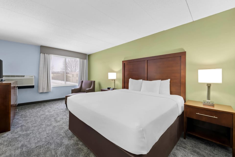 Premium bedding, desk, laptop workspace, blackout drapes