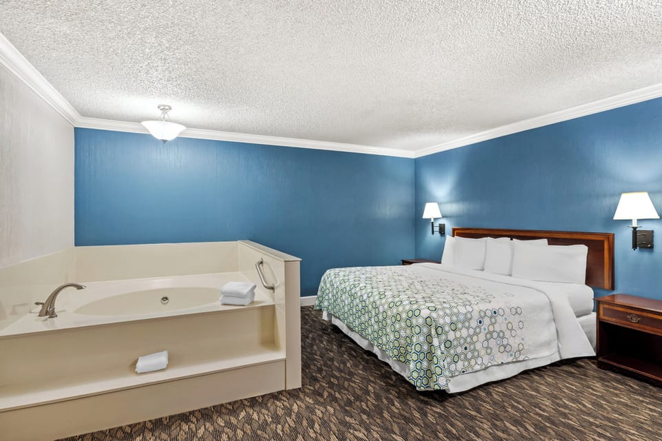 Suite, 1 King Bed, Non Smoking, Jetted Tub | Desk, laptop workspace, blackout drapes, iron/ironing board