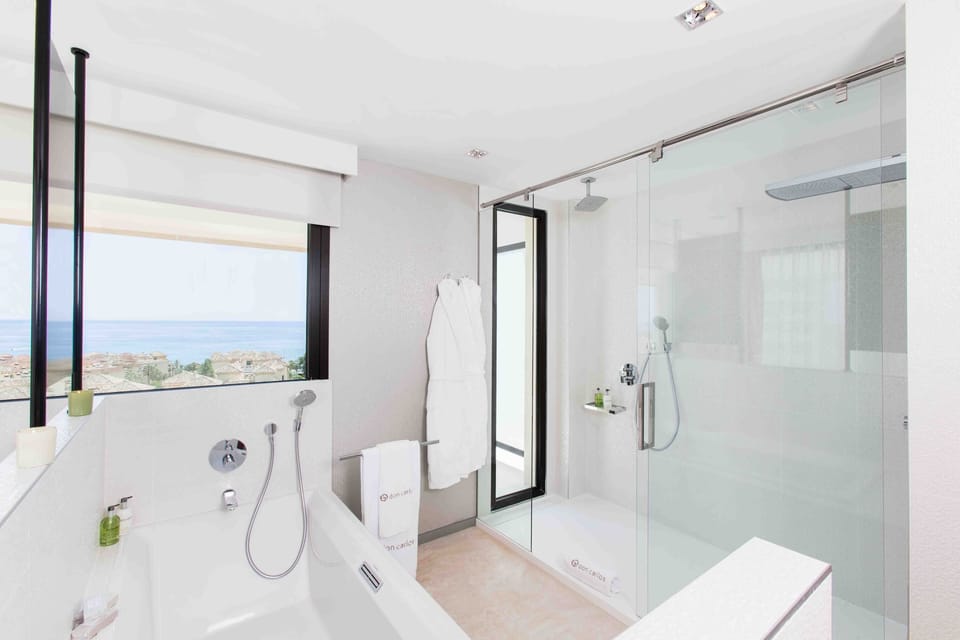 Deluxe Suite, Terrace, Sea View | Bathroom | Separate tub and shower, rainfall showerhead, designer toiletries