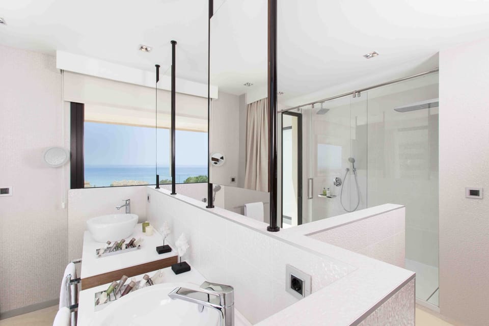 Deluxe Suite, Terrace, Sea View | Bathroom | Separate tub and shower, rainfall showerhead, designer toiletries