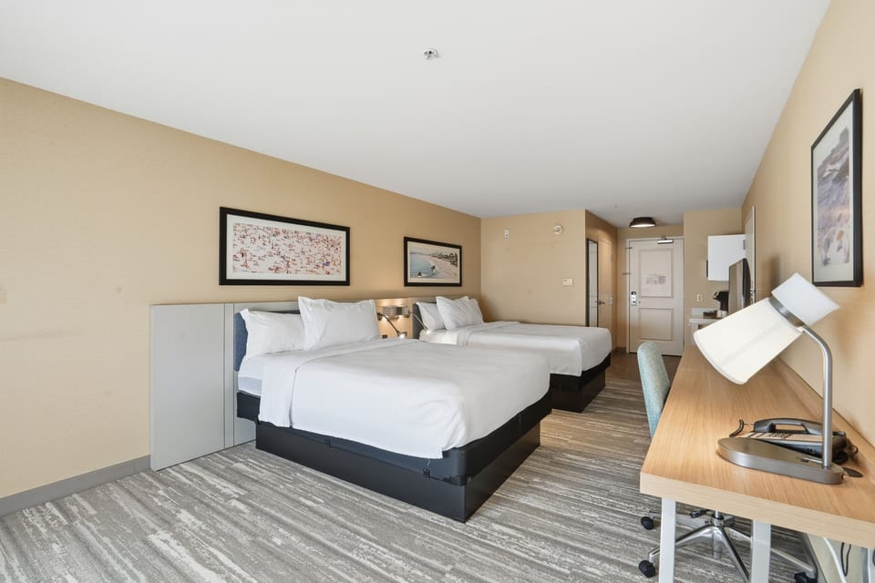 Premium bedding, desk, laptop workspace, blackout drapes