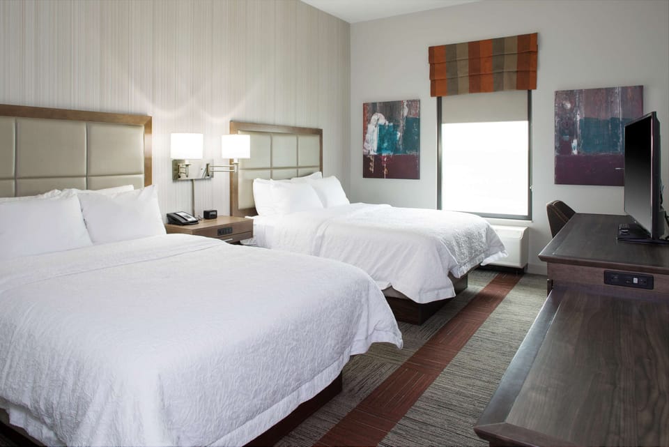 Hypo-allergenic bedding, desk, laptop workspace, blackout drapes