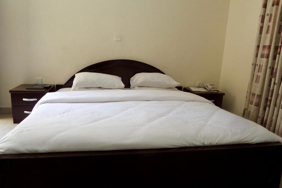 Desk, laptop workspace, bed sheets