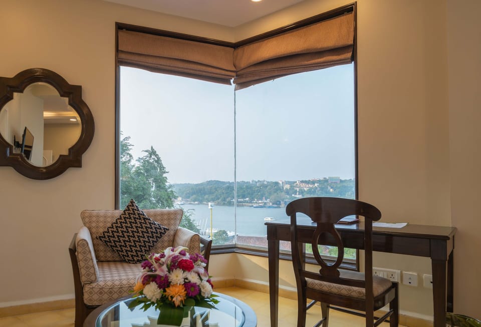 Superior Room, River View | Minibar, in-room safe, desk, iron/ironing board