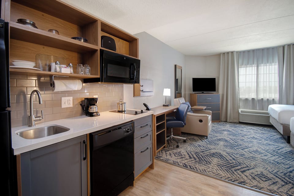 Premium bedding, desk, laptop workspace, blackout drapes