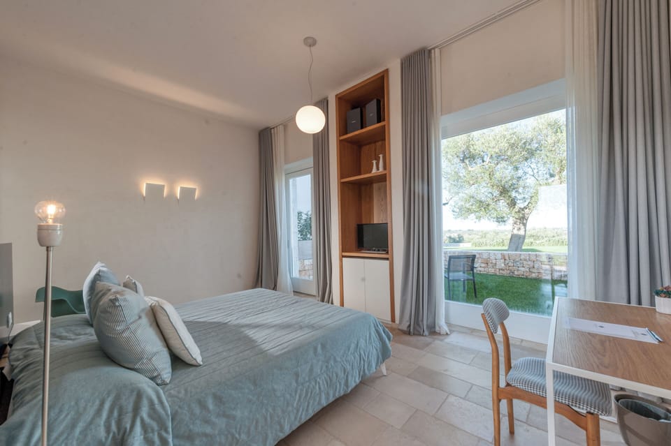 Deluxe Room, Patio, Garden Area | Premium bedding, minibar, in-room safe, individually decorated