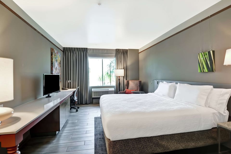 Premium bedding, desk, laptop workspace, iron/ironing board