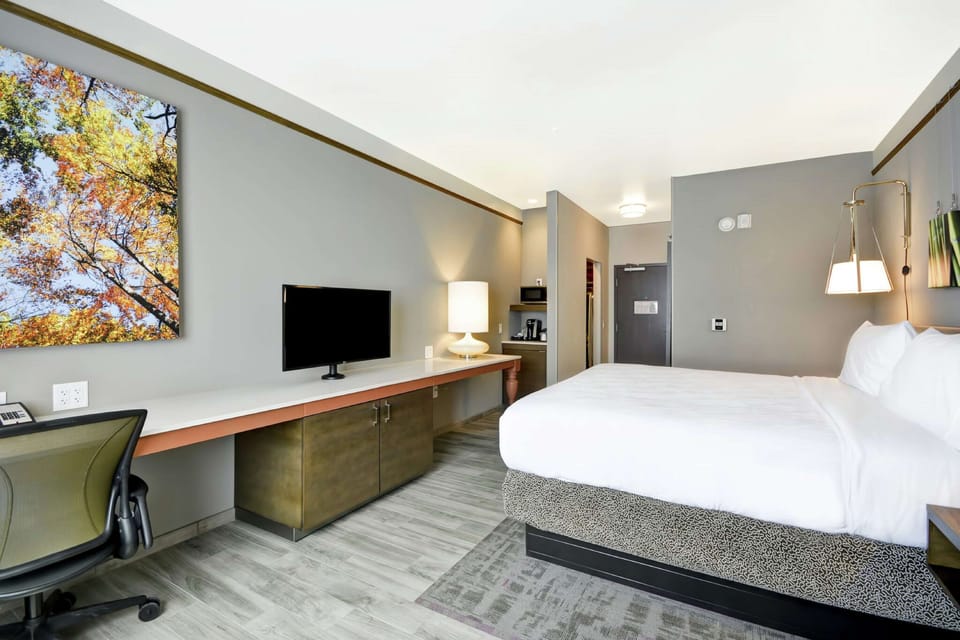 Premium bedding, desk, laptop workspace, iron/ironing board