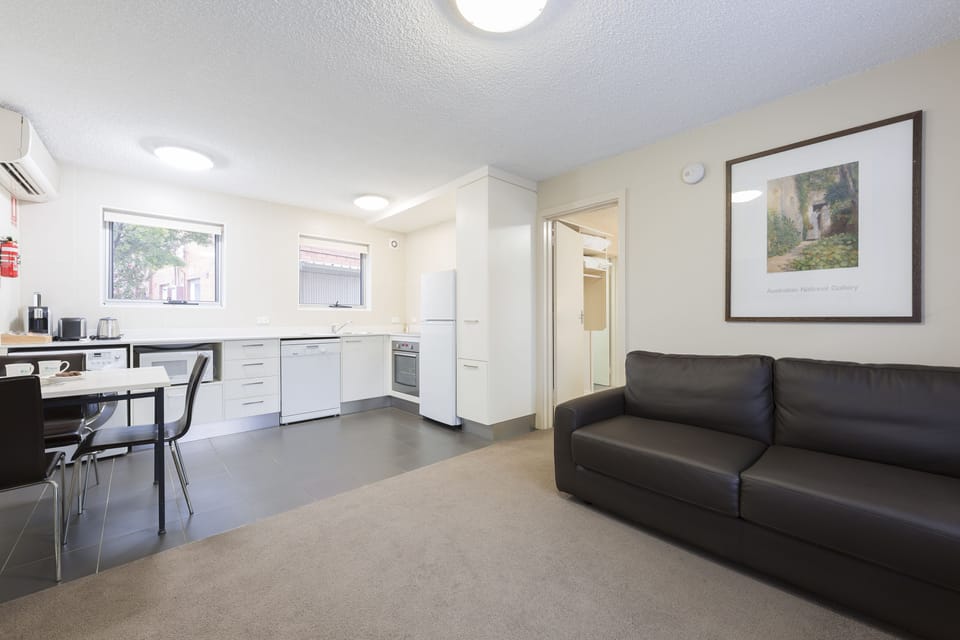 Executive One Bedroom Apartment | Living area | 30-inch flat-screen TV with digital channels, TV