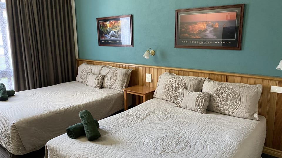 Room 12: Standard Two Queens with 50 inch Smart TV located on Ground Floor | Iron/ironing board, free WiFi, bed sheets