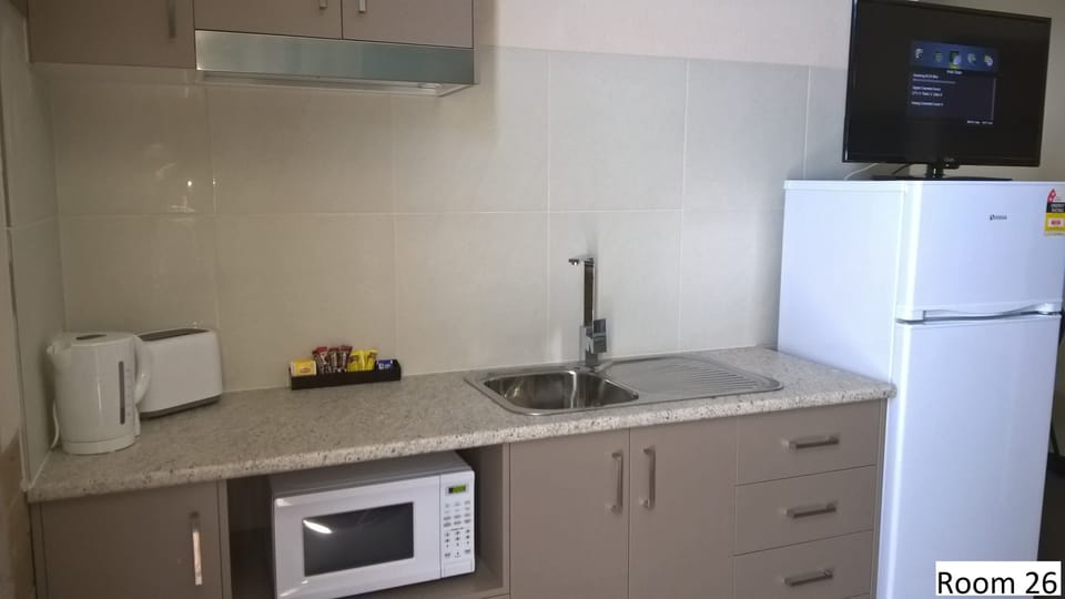 Room 26: Family Room with 50 inch Smart TV located on First Floor | Private kitchenette | Microwave, coffee/tea maker, electric kettle