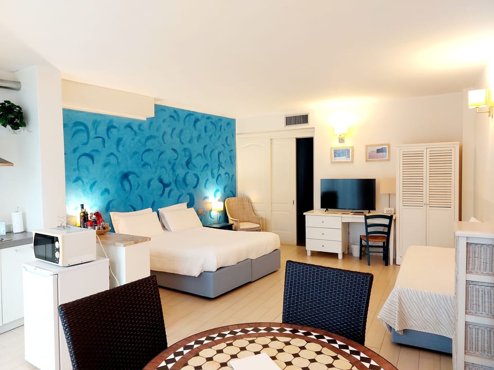 Apartment, 1 Bedroom, Patio, Garden Area | Living area | 43-inch LED TV with satellite channels, books