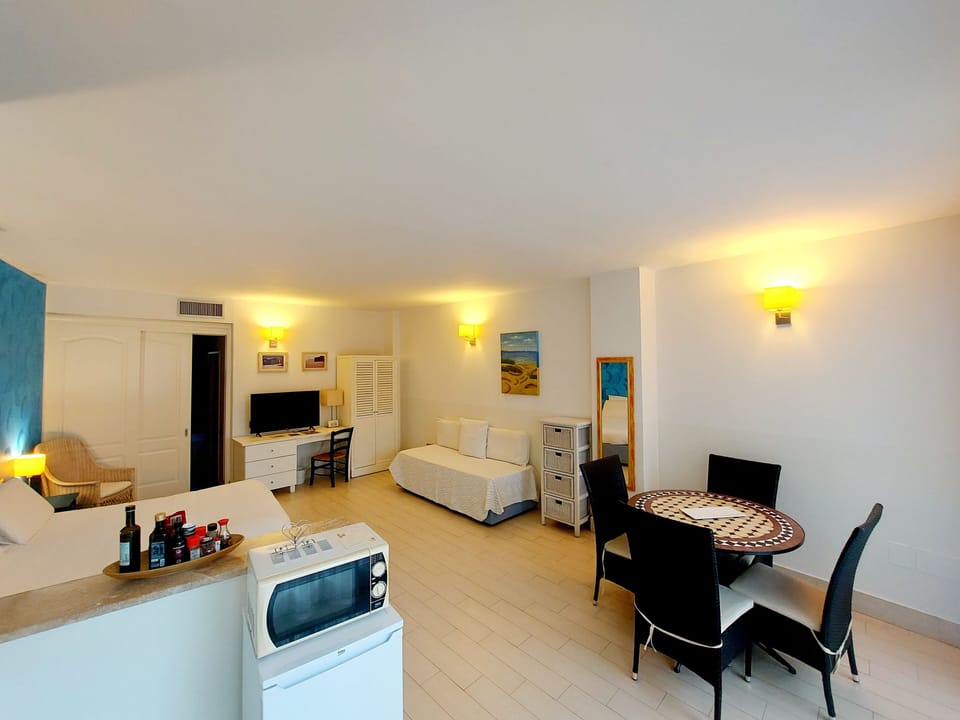 Apartment, 1 Bedroom, Patio, Garden Area | Living area | 43-inch LED TV with satellite channels, books