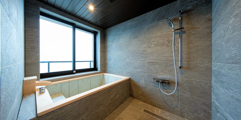 Deluxe Twin Room | Bathroom | Combined shower/tub, hair dryer, slippers, bidet