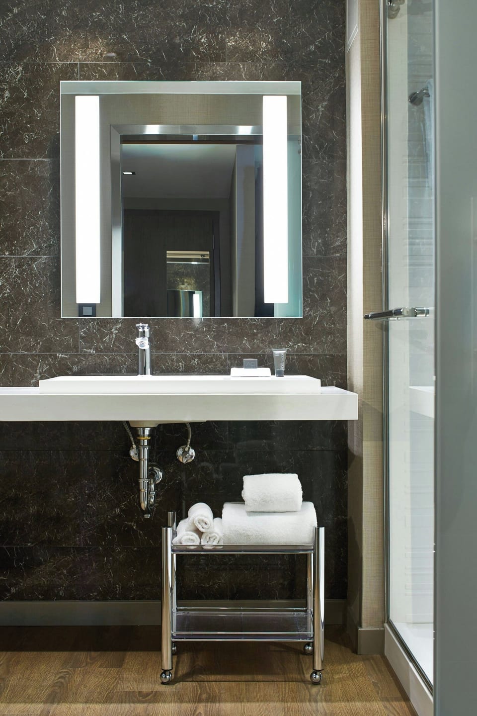 Shower, designer toiletries, hair dryer, towels