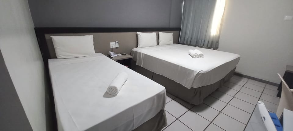 Economy Triple Room | In-room safe, desk, blackout drapes, free cribs/infant beds