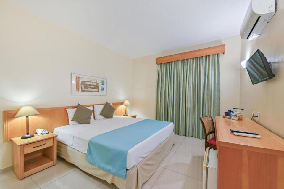 Standard Double Room | Minibar, in-room safe, desk, blackout drapes