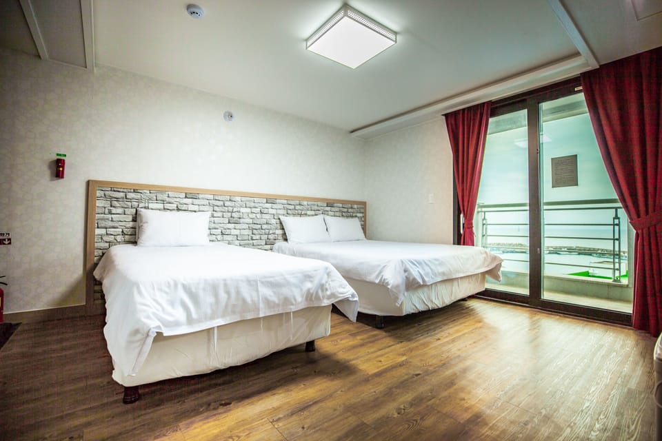 Premium bedding, laptop workspace, blackout drapes, soundproofing