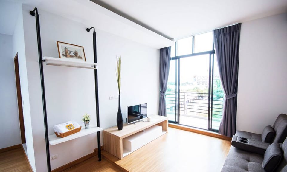 Family Quadruple Room | Living area | 32-inch flat-screen TV with digital channels, TV