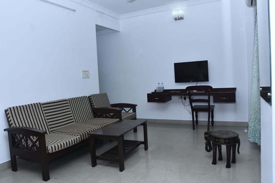Family Room | Desk, iron/ironing board, bed sheets