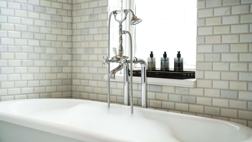 Designer toiletries, hair dryer, slippers, towels
