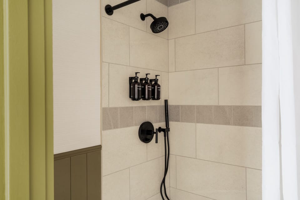 Shower, designer toiletries, hair dryer, towels