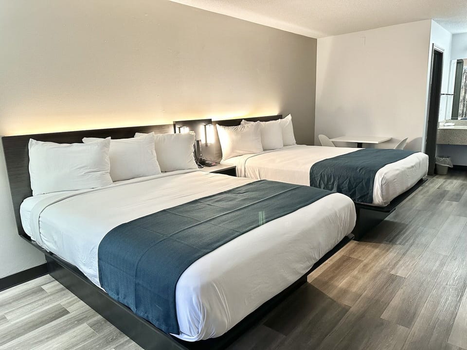 Desk, laptop workspace, blackout drapes, bed sheets