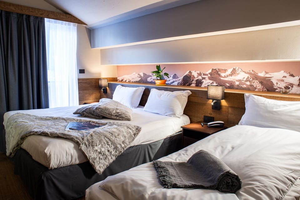 Deluxe Triple Room | Down comforters, desk, laptop workspace, blackout drapes