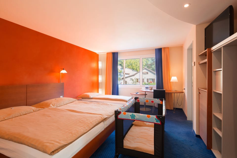 Family Room | Premium bedding, in-room safe, desk, iron/ironing board