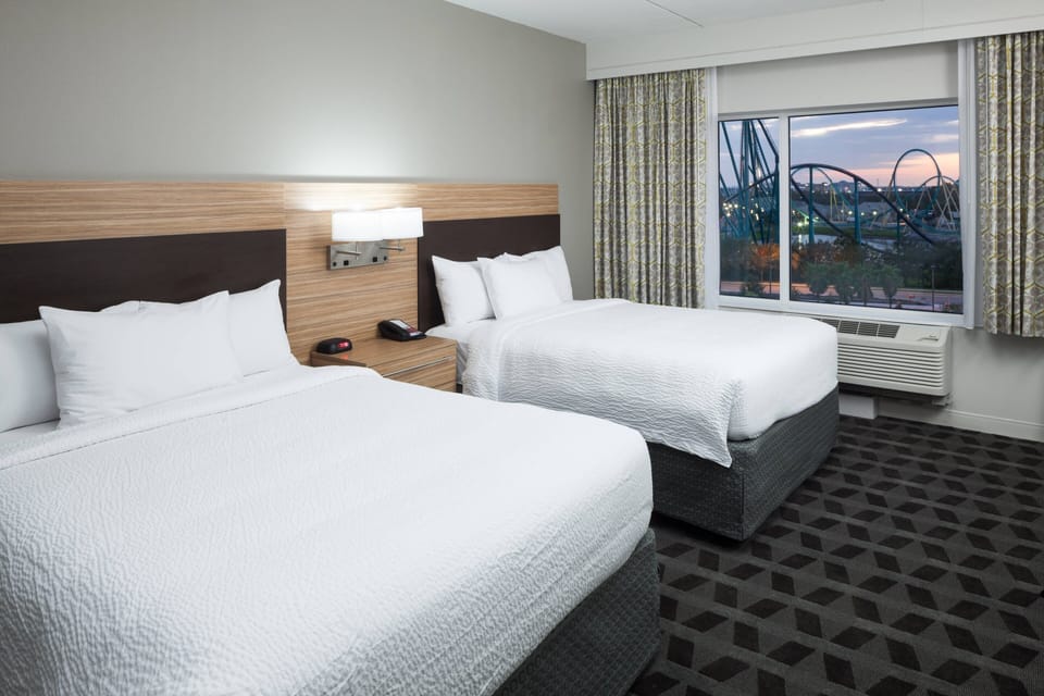 Premium bedding, desk, laptop workspace, blackout drapes