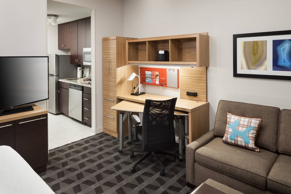 Premium bedding, desk, laptop workspace, blackout drapes