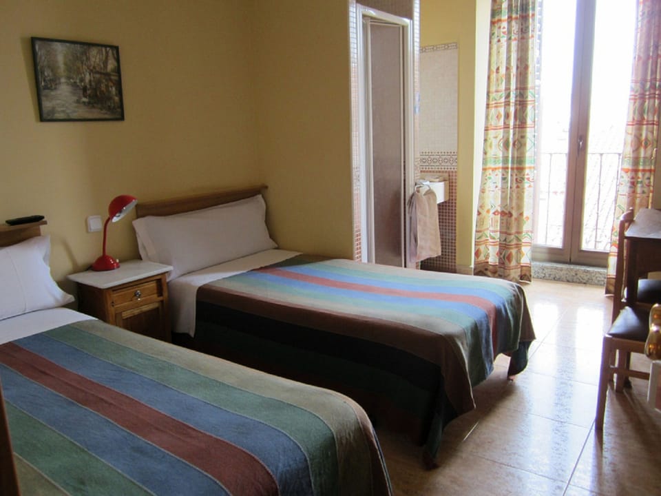 Double Room, Shared Bathroom (Private Shower and Sink) | Desk, blackout drapes, iron/ironing board, free WiFi