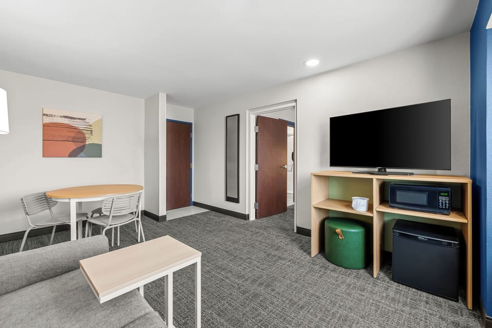 Suite, 2 Queen Beds | Desk, laptop workspace, blackout drapes, iron/ironing board