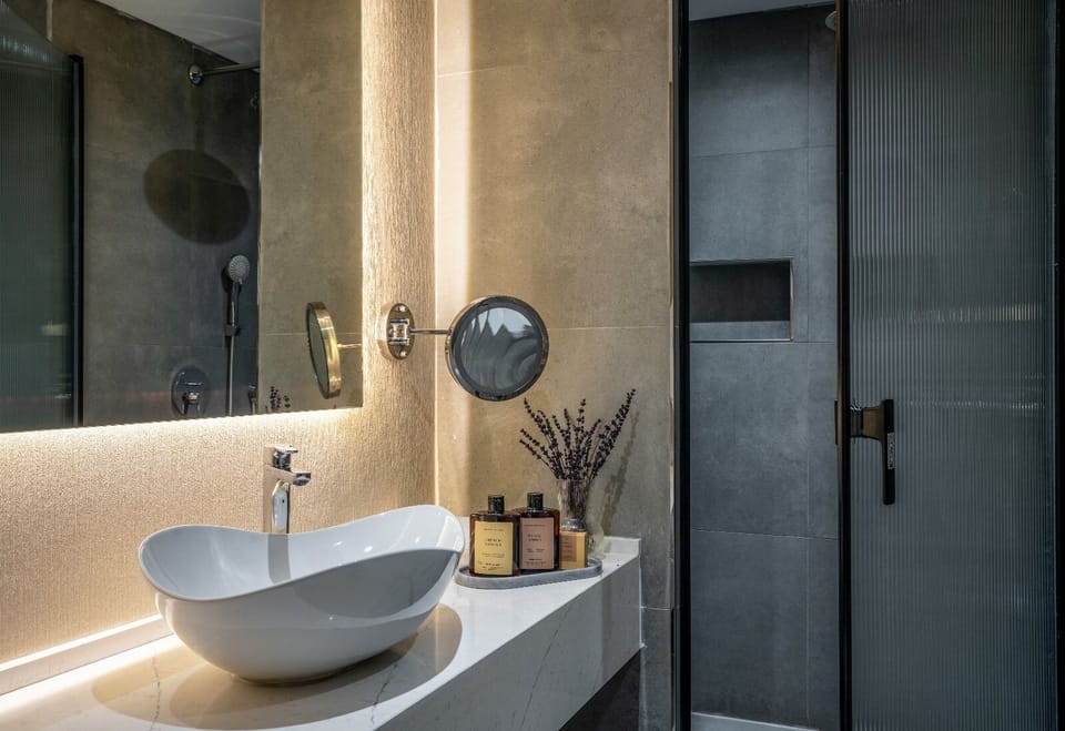 King Room | Bathroom | Deep soaking tub, rainfall showerhead, designer toiletries, hair dryer