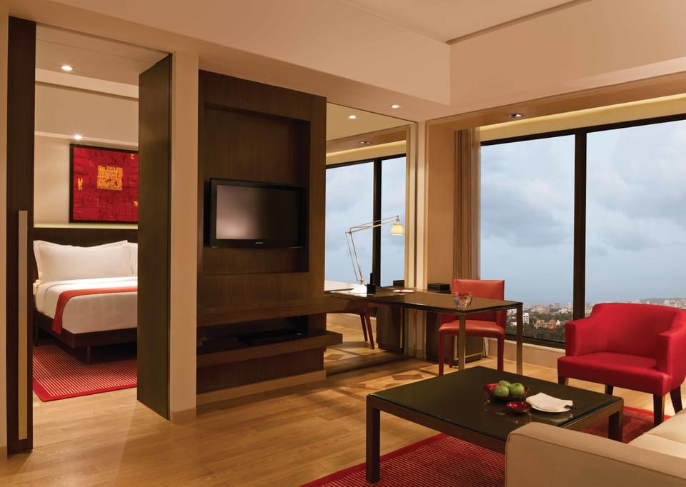 Club Suite | Living room | 32-inch LCD TV with satellite channels, TV, DVD player