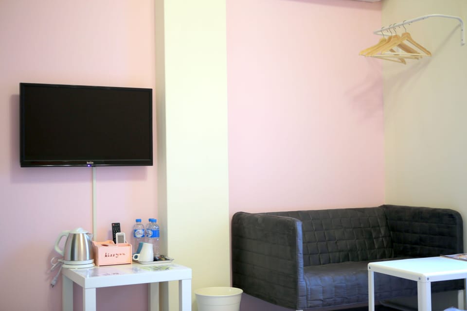 Triple Room (Pink) | Living area | 42-inch flat-screen TV with digital channels, TV