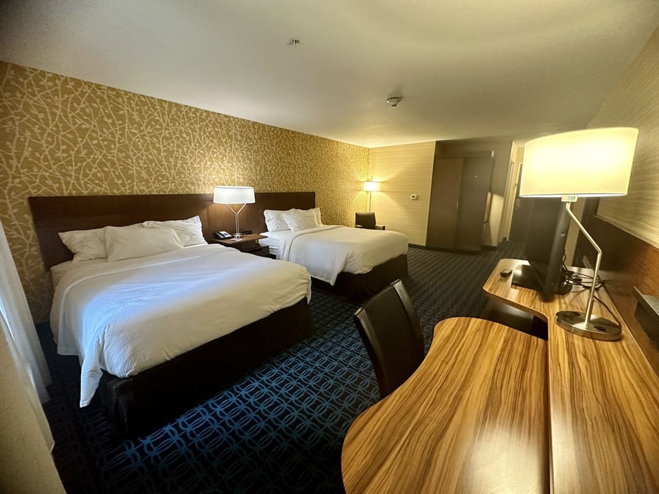 Premium bedding, desk, laptop workspace, blackout drapes