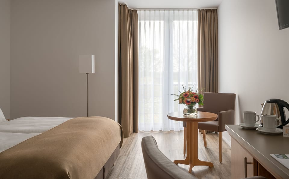 Hypo-allergenic bedding, desk, laptop workspace, blackout drapes