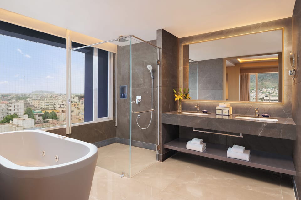 Suite, 1 King Bed (Vivanta) | Bathroom | Free toiletries, hair dryer, bathrobes, towels