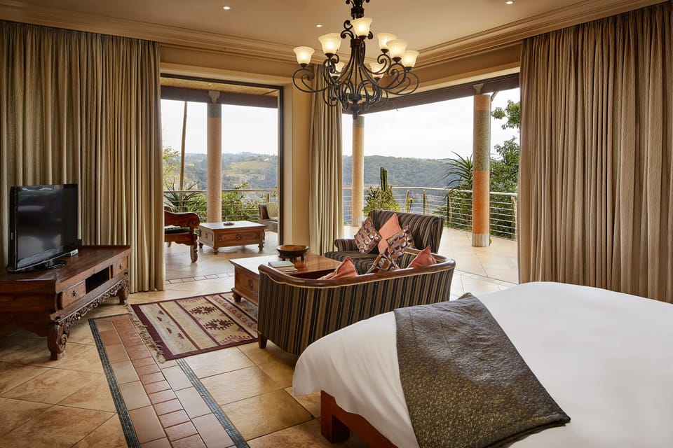 Presidential Suite | Living room | 32-inch flat-screen TV with digital channels, TV, books