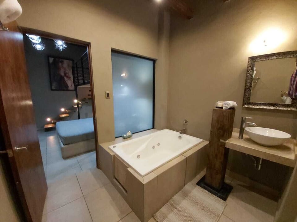 Design Suite, 1 Bedroom, Bathtub, Ground Floor | Bathroom | Heated floors, towels, soap, shampoo