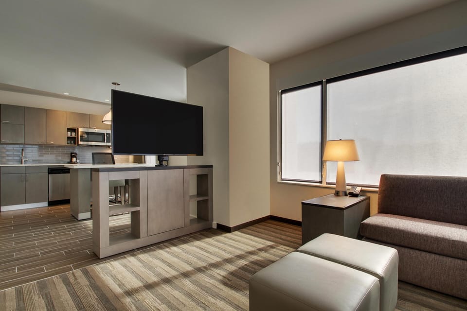 Hypo-allergenic bedding, desk, laptop workspace, blackout drapes