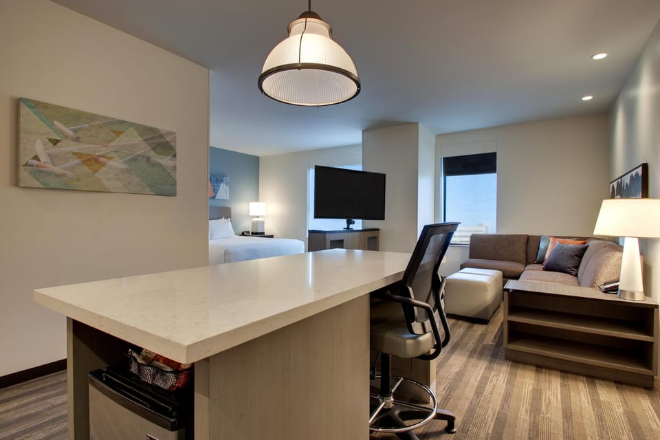 Hypo-allergenic bedding, desk, laptop workspace, blackout drapes