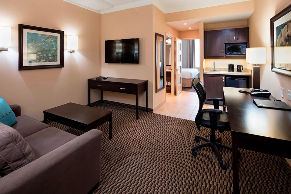 Premium bedding, desk, laptop workspace, blackout drapes
